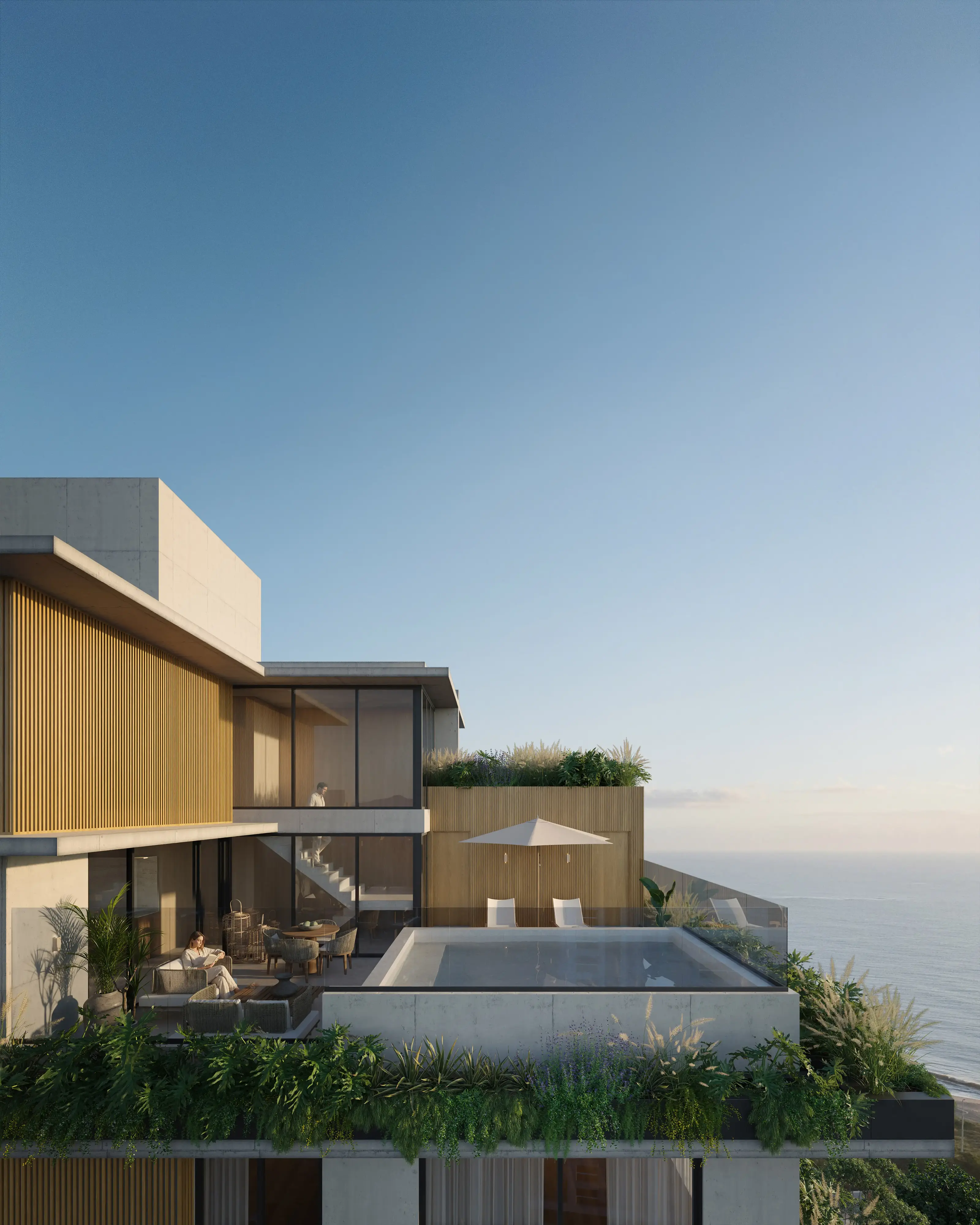 Vista aérea da cobertura do Nuar Residence em Balneário Piçarras, com piscina privativa, área de estar ao ar livre com guarda-sol, jardins e vista panorâmica para o mar ao entardecer