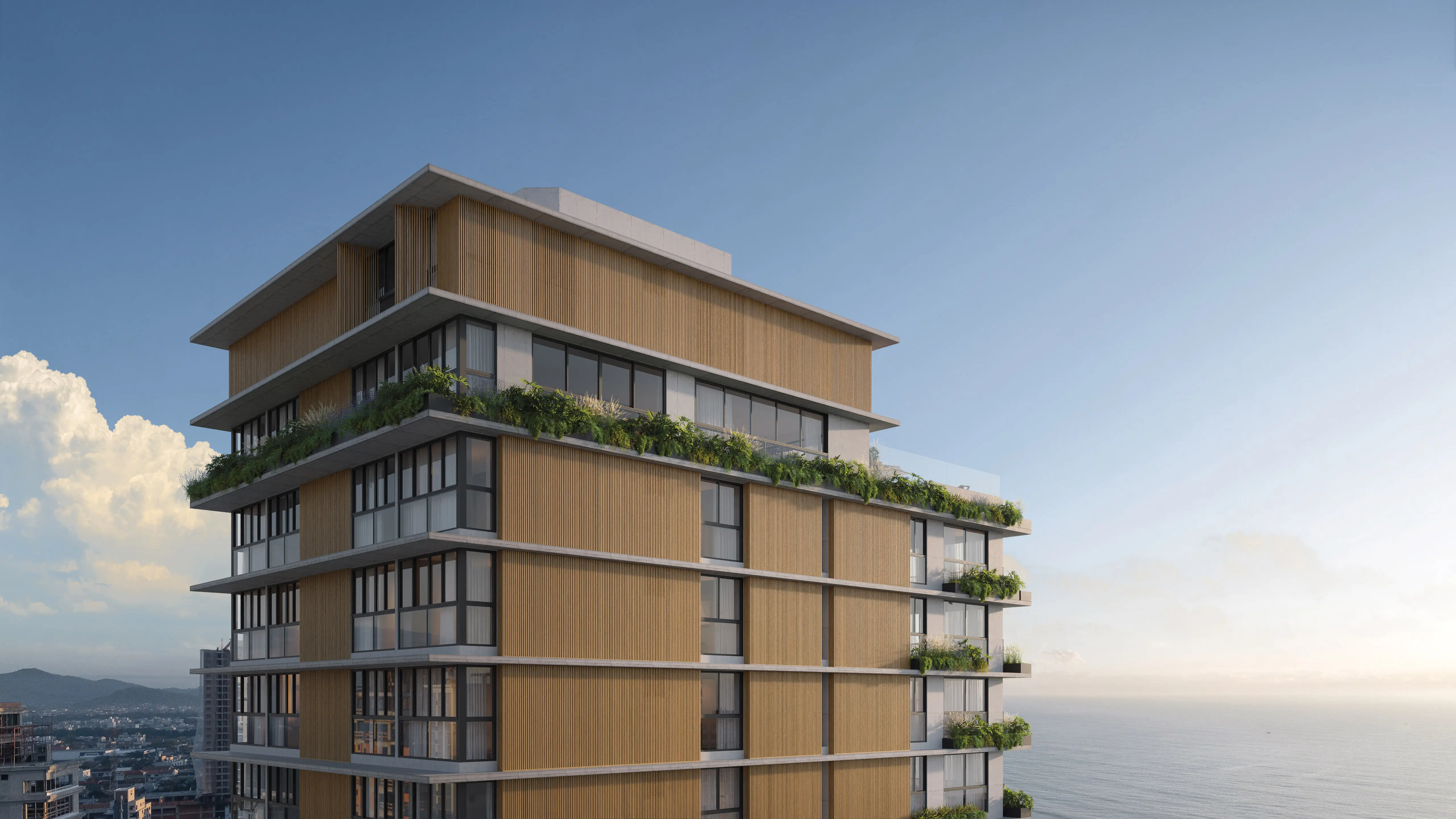 Vista aérea lateral da torre do Nuar Residence em Balneário Piçarras, com fachada em ripas de madeira, amplas esquadrias, varandas com jardins em cada pavimento, mar e cidade ao fundo