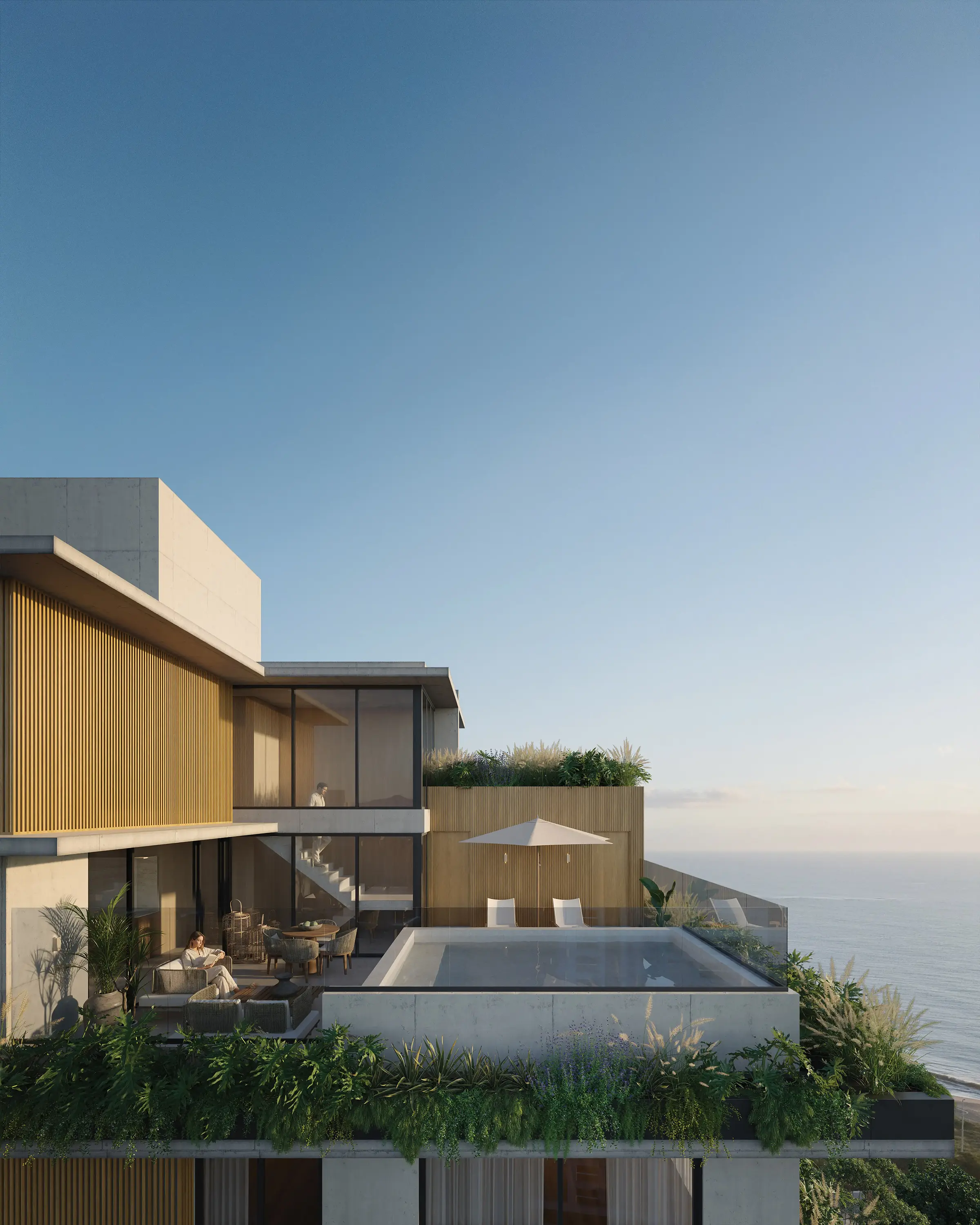 Vista aérea do terraço do Nuar Residence em Balneário Piçarras, com piscina, área de estar ao ar livre com guarda-sol, vegetação exuberante, fachada em ripas de madeira e vista para o mar