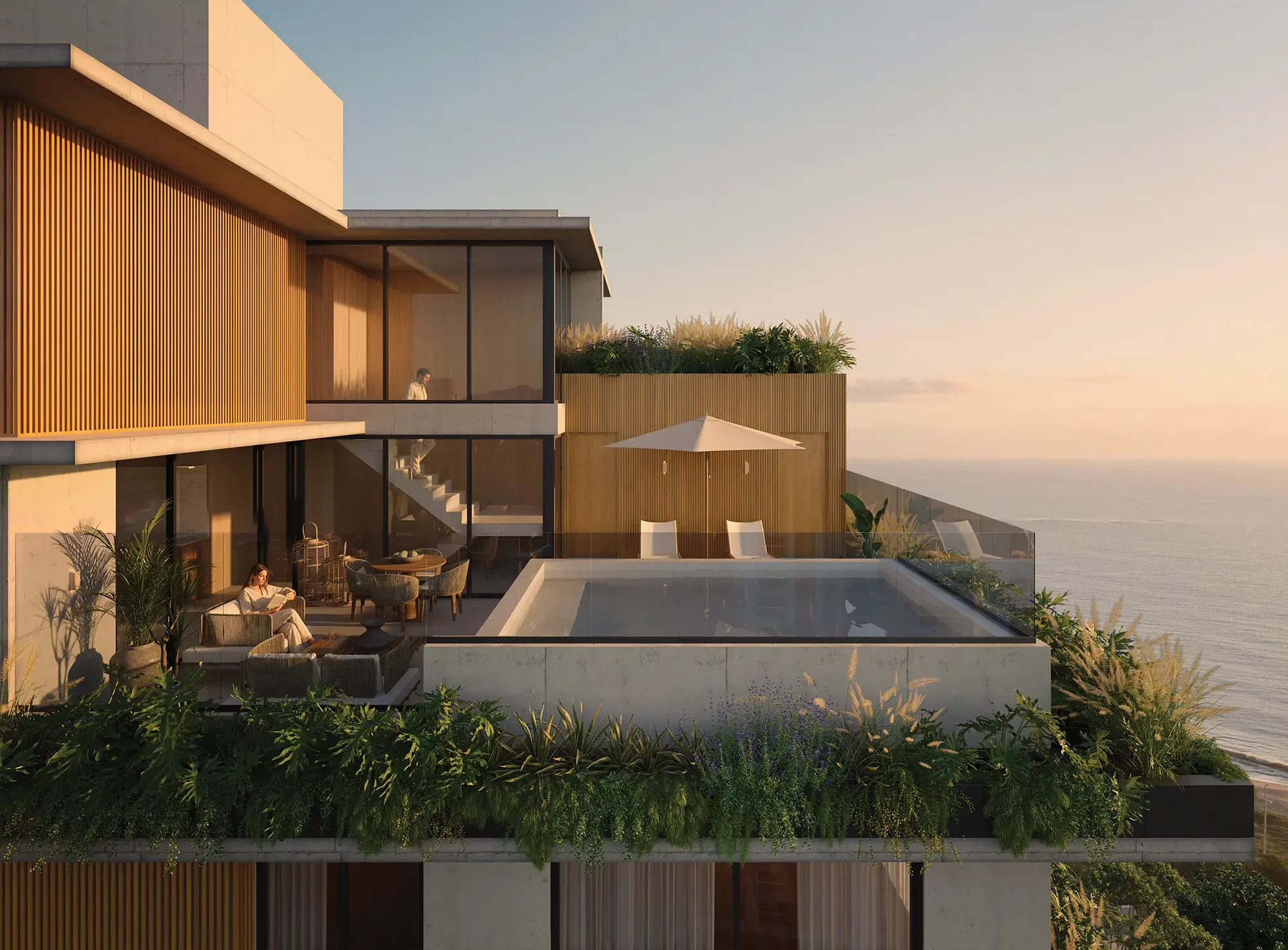Vista aérea da cobertura do Nuar Residence em Balneário Piçarras, com piscina privativa, área de estar ao ar livre com guarda-sol, jardins e vista panorâmica para o mar ao entardecer