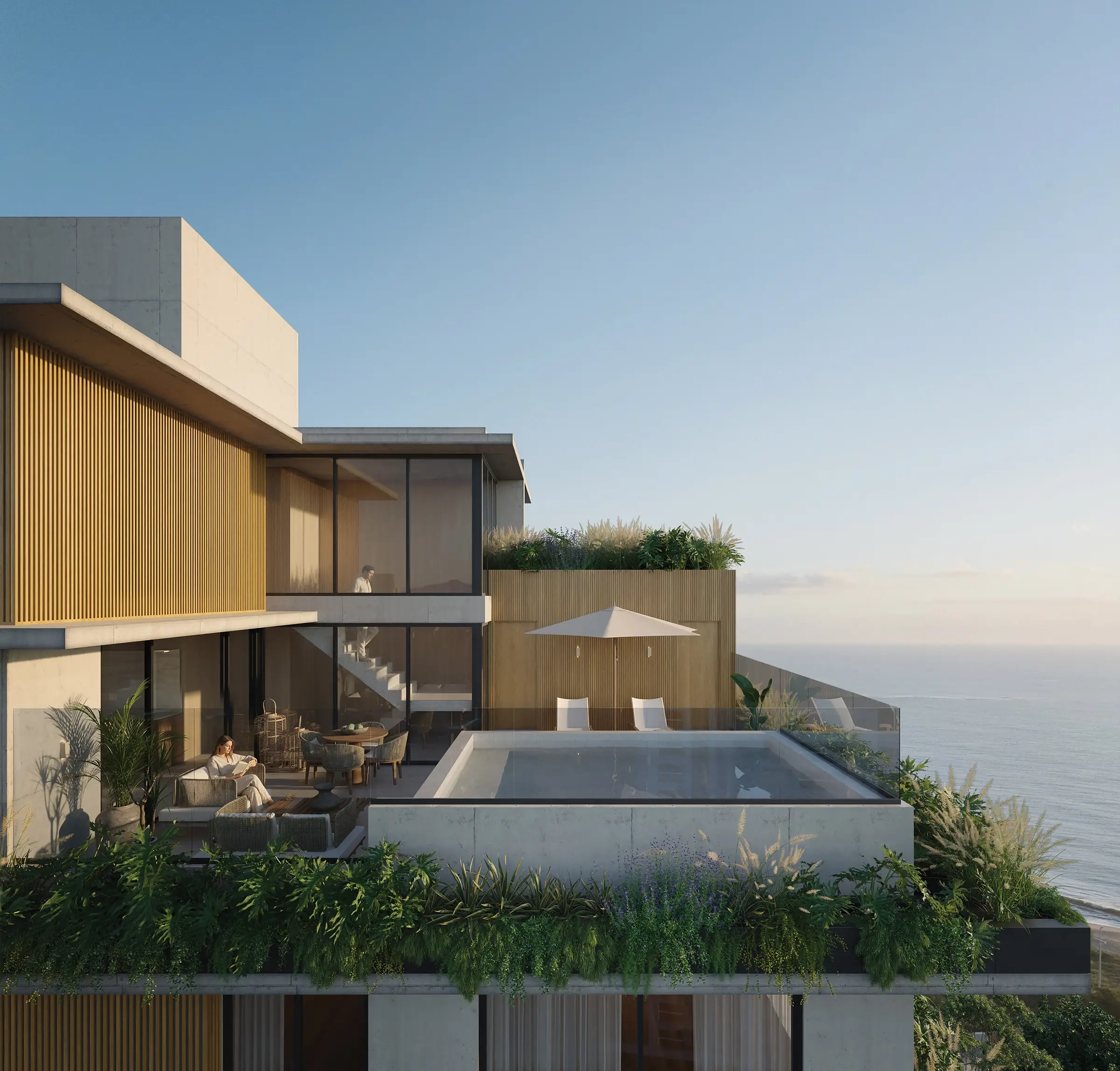 Vista aérea do terraço do Nuar Residence em Balneário Piçarras, com piscina, área de estar ao ar livre com guarda-sol, vegetação exuberante, fachada em ripas de madeira e vista para o mar